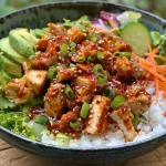 Nahaufnahme einer Schüssel mit scharfem koreanischen BBQ-Hühnchen und Reis.