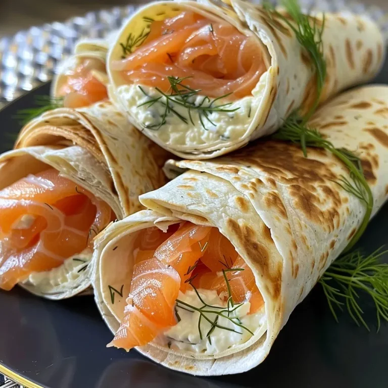 ['Close-up of wraps filled with smoked salmon and cream cheese, showcasing fresh ingredients.', 'Side view of a delicious smoked salmon wrap with cream cheese and herbs, highlighting vibrant colors.', 'Juicy wraps featuring salmon and cream cheese, arranged with dill for garnish against a neutral background.', 'A close-up shot of a salmon wrap, with a focus on the creamy filling and fresh herbs.']