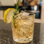 ['A refreshing non-alcoholic pear cocktail garnished with rosemary and served in a glass.', 'Close-up view of a fruity alkoholfreier Birnen Cocktail with a slice of pear and spices.', 'Side angle of a sparkling pear cocktail, topped with fresh herbs and spices.', 'Detailed image of an alkoholfreier Birnen Cocktail, showcasing its vibrant ingredients.']