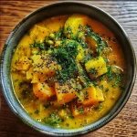 ['Close-up of a warm Ayurvedic soup with vibrant vegetables.', 'Side view of a bowl filled with Ayurvedic soup, showcasing fresh ingredients.', 'Delicious Ayurvedic soup with ginger and spices in a rustic bowl.', 'Lush, hearty Ayurvedic soup featuring carrots, zucchini, and herbs.']