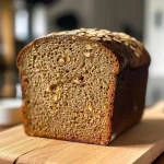 ['Close-up of a loaf of Haselnussbrot showcasing its texture and crust.', 'Side view of freshly baked Haselnussbrot displaying its golden-brown crust and nutty interior.', 'Juicy Haselnussbrot with visible hazelnuts and a rustic appearance.', 'Detailed view of a sliced Haselnussbrot revealing its moist crumb and nutty flavor.']