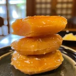 ['Close-up view of moist Hokkaido Kürbis Kekse arranged on a plate.', 'Side view of freshly baked Hokkaido Kürbis Kekse with a golden-brown crust.', 'Tasty Hokkaido Kürbis Kekse displayed with a rustic background.', 'Detailed shot of soft Hokkaido Kürbis Kekse highlighting pumpkin flavor.']