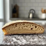 ['Close-up of a freshly baked Kohlbrot showing a golden crust and juicy texture.', 'Side view of a sliced Kohlbrot with visible layers of cabbage and onions.', 'A piece of Kohlbrot on a wooden board with steam rising from its surface.', 'A beautifully presented Kohlbrot with a crispy crust and soft interior.']