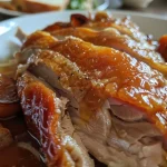['Close-up view of a creamy pumpkin spread with herbs and seeds.', 'Side-angle photo of Kürbisaufstrich served in a bowl, garnished with parsley.', 'Rich butternut squash dip highlighted with pine nuts and chili flakes.', 'Delicious pumpkin spread on a wooden table, ready for dipping.']