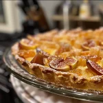 ['A close-up side view of a ricotta and fig crostata showcasing the creamy filling and sliced figs.', 'Detailed view of a rustic Italian tart filled with ricotta cheese and fresh fig slices.', 'An appetizing slice of crostata with a golden crust and rich ricotta filling topped with figs.', 'Side perspective of a fig crostata highlighting its flaky pastry and vibrant fruit toppings.']