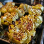['Close-up side view of roasted Brussels sprouts glistening with olive oil and spices.', 'Juicy, golden-brown roasted Brussels sprouts arranged attractively on a plate.', 'Freshly roasted Brussels sprouts with a sprinkle of seasoning, showcasing their vibrant color.', 'A delicious serving of oven-roasted Brussels sprouts, garnished and ready to eat.']