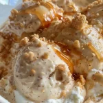 ['Creamy caramel dip in a bowl with a smooth texture and a side view.', 'Close-up side view of a delicious caramel dip garnished with caramel topping.', 'Rich and creamy caramel dip displayed in a beautiful bowl on a surface.', 'A textural close-up of a creamy caramel dip, emphasizing its smooth consistency.']