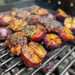 ['Close-up view of grilled chicken and plum skewers with juicy meat and vibrant fruit.', 'Side view of colorful skewers featuring chicken pieces and quartered plums on a grill.', 'Juicy grilled chicken and plum skewers arranged on a plate, showcasing their delicious textures.', 'Detailed shot of skewers with marinated chicken and plums, perfectly charred on the grill.']