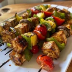 ['Close-up view of vegetable kabobs with tofu on skewers, showcasing vibrant colors and grill marks.', 'Juicy tofu and vegetable skewers arranged on a plate, highlighting tomatoes, mushrooms, and green pepper.', 'Grilled vegetable and tofu kabobs, featuring a selection of fresh ingredients like zucchini and pineapple.', 'Side view of colorful tofu skewers with BBQ glaze, emphasizing the texture and juiciness of the ingredients.']