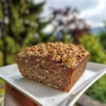 ['Close-up view of sliced Schnelles Haselnussbrot showcasing its texture and whole hazelnuts.', 'Side view of freshly baked Schnelles Haselnussbrot highlighting the crust and nutty interior.', 'Juicy Schnelles Haselnussbrot presented on a wooden cutting board, emphasizing its rustic appeal.', 'Detailed image of Schnelles Haselnussbrot with visible hazelnuts and a golden crust from an iPhone 15 Pro.']