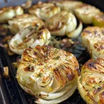 ['Juicy grilled Spitzkohl with a golden-brown exterior and garnished with herbs.', 'Close-up of grilled Spitzkohl, showcasing its charred leaves and vibrant herbs.', 'Side view of succulent grilled Spitzkohl, highlighting its rich colors and textures.', 'Freshly grilled Spitzkohl, drizzled with olive oil and sprinkled with parsley.']
