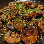 ['A vibrant close-up of a pan filled with sautéed topinambur and shiitake mushrooms, highlighting their rich textures.', 'Side view of a delicious stir-fry with golden topinambur, dark shiitake mushrooms, and colorful herbs in a frying pan.', 'Juicy topinambur and shiitake mushrooms cooked together, garnished with fresh herbs in a close-up image.', 'Close-up of a skillet showcasing tender topinambur and shiitake mushrooms, infused with spices and herbs.']