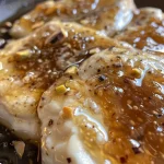 ['Close-up of creamy goat cheese dip with fig jam and pistachios.', 'Side view of fig jam and goat cheese dip garnished with nuts.', 'Goat cheese dip mixed with fig preserves, topped with chopped pistachios.', 'Textured dip of goat cheese and fig jam served in a rustic bowl.']