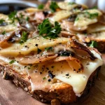 ['Close-up view of golden-brown Überbackener Toast topped with cheese and pear.', 'Side angle of a slice of Überbackener Toast with melted cheese, walnuts, and green onions.', 'Juicy Überbackener Toast featuring creamy sauce and garnished with pear and nuts.', 'Detailed image of a crispy toast slice layered with toppings and cheese, ready to serve.']
